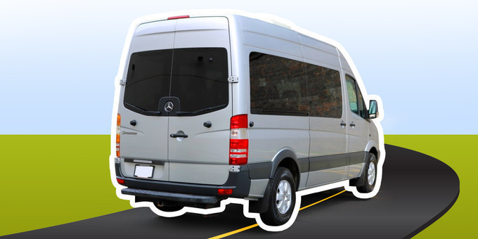 Sprinter Van moving on road highligted with greenary in background