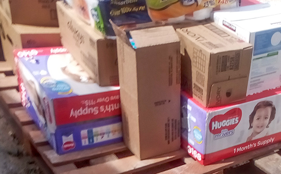 Carring food, water and basic needs items by a forklift.